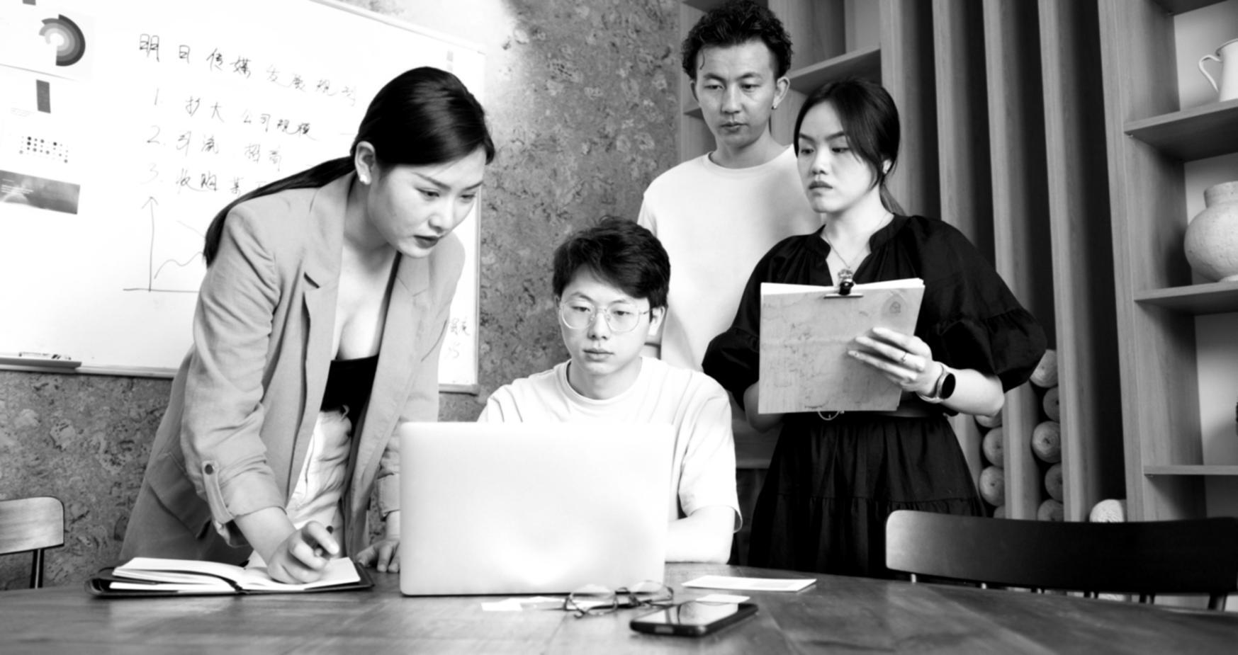 Marketing professionals collaborating in modern workspace during strategy session